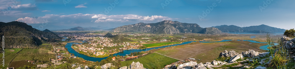 A beautiful panorama of the Dalyan river valley with a view of the town, mountains and Iztuzu beach from the view point of the ancient city of Kaunos
