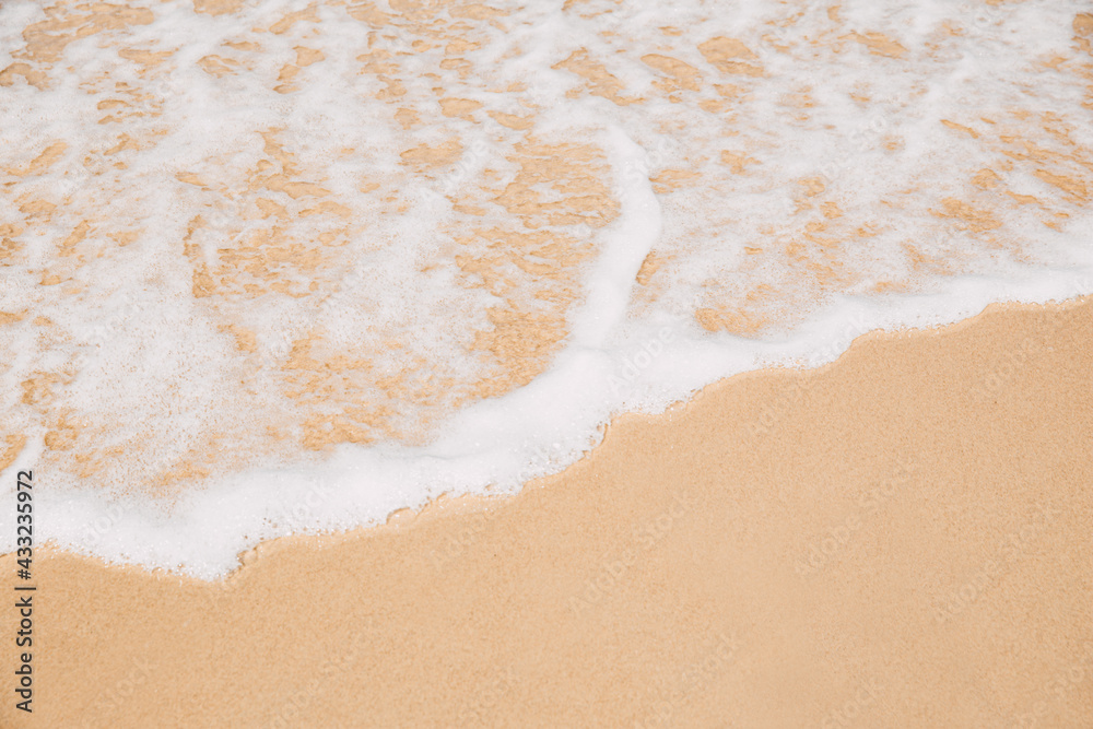 Sea wave coming on sandy beach view from top Sea wave coming on sandy beach view from top