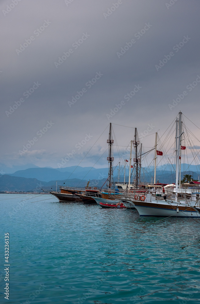 Yachts in the port of Fethiye, Turkey in the evening against the backdrop of mountains