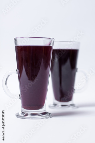 two glasses with sweet strawberry juice isolated