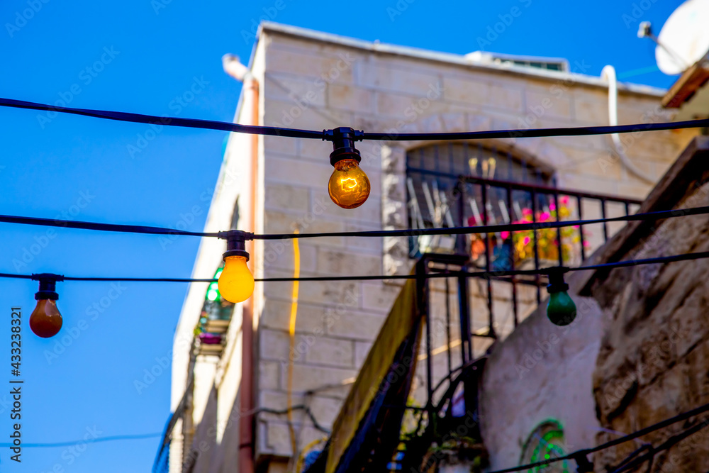 Street of the old city of Jerusalem decorated with bright multi-colored bulbs for Ramadan in the Arab quarter of Jerusalem's Old City.