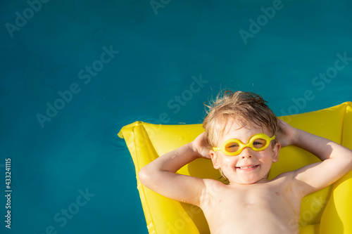 Happy child swimming on summer vacation