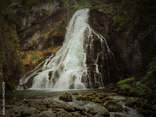 Waterfall in the middle of the forest in cloudy weather  water landscape