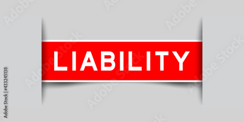 Inserted red color label sticker with word liability on gray background