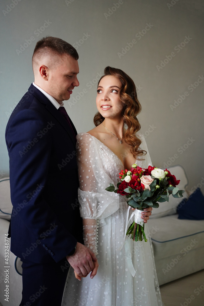 The groom with a bouquet of flowers for the bride on the wedding day. The groom with a bouquet of flowers for the bride on the wedding day.