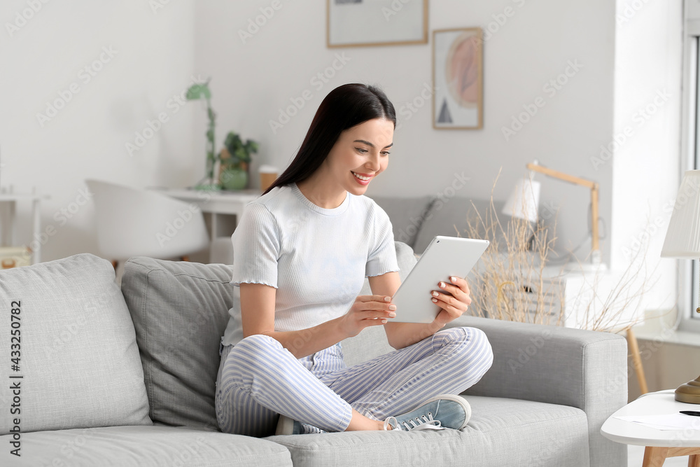 Beautiful young woman with tablet computer at home Beautiful young woman with tablet computer at home