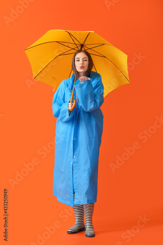 Stylish young woman in rain...
