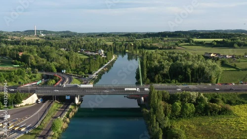 Top view of the movement of cars on the Autobahn bridge. Car toll roads in Italy. Aerial view of a motorway in Europe. Flight over toll roads north of Italy. Slow flight over the Autobahn. photo