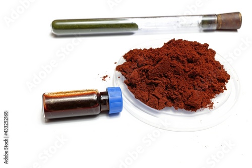 On a white background is shown the reagent for developing fingerprints called sangre de drago in powder form and in liquid form dissolved in a vial, in medicine it has healing properties. 
