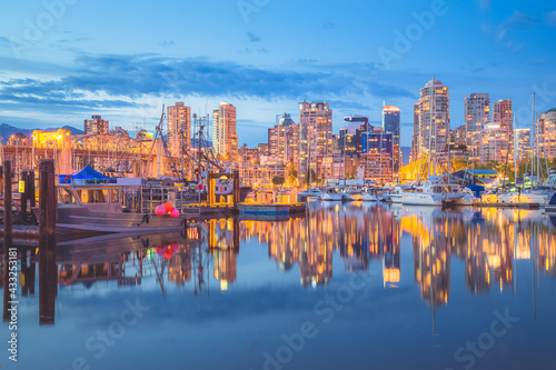 Evening cityscape view from Granville Island and Vancouver, BC downtown waterfront skyline and Burrard Inlet.
