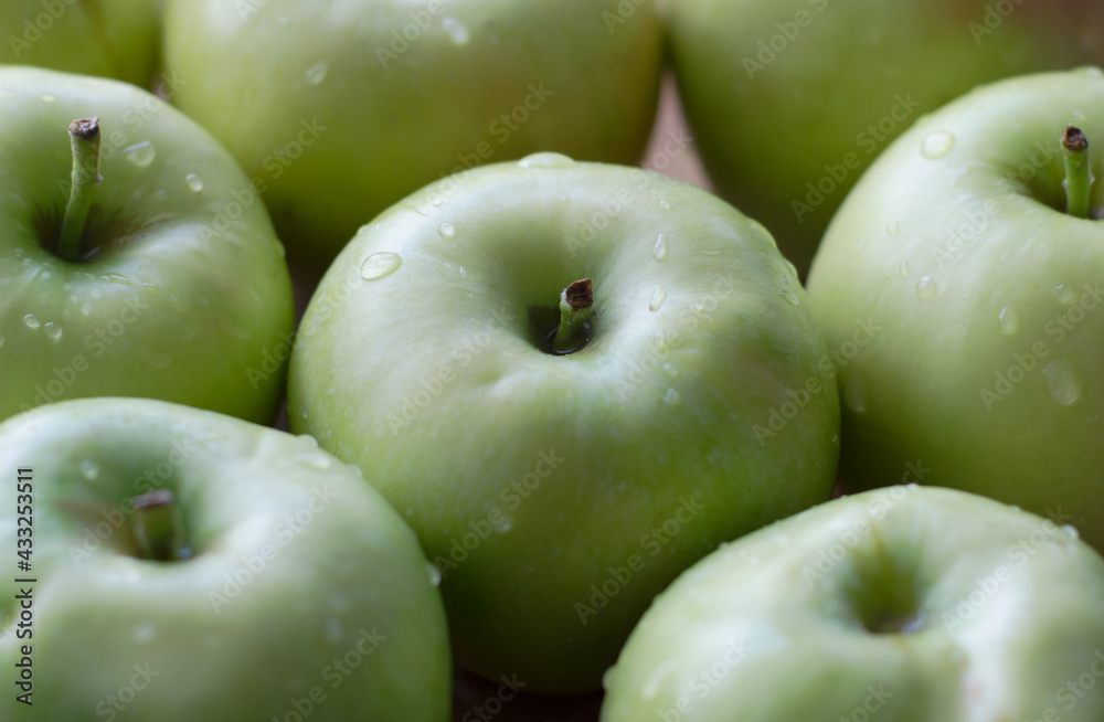 Background of green apples with water droplets, close-up Background of green apples with water droplets, close-up
