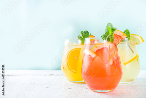Summer cold drinks, fruit lemonade sangria cocktail, infused beverages with various citrus - orange, lemon, grapefruit, lime, with fresh fruits copy space