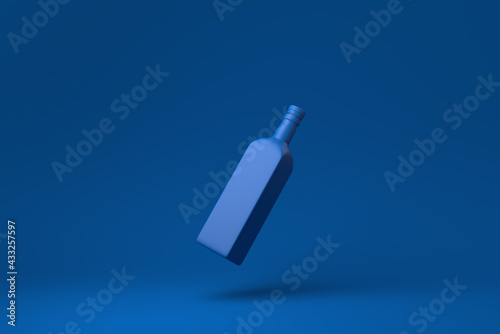 Blue brandy bottle floating in blue background. minimal concept idea creative. monochrome. 3D render.