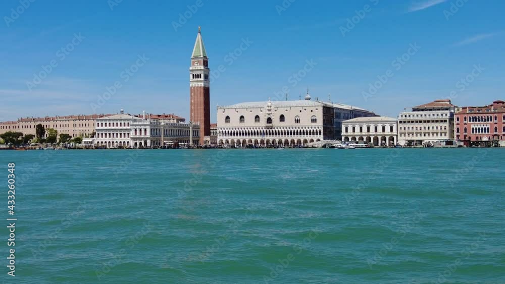 San Marco bell tower in San Marco square in Venice with Saint Mark Basilica of the famous Venetian city of Italy. sea view from Giudecca canal by cruise boat trip in Venetian lagoon by ferry boat. San Marco bell tower in San Marco square in Venice with Saint Mark Basilica of the famous Venetian city of Italy. sea view from Giudecca canal by cruise boat trip in Venetian lagoon by ferry boat.