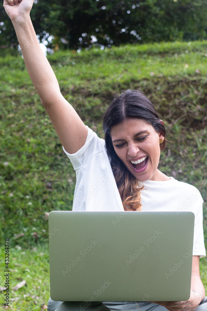 Happy young latina woman celebrate receiving amazing news by laptop Happy young latina woman celebrate receiving amazing news by laptop