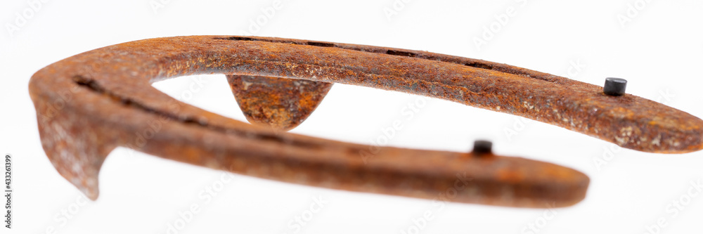 Panoramic image. Rusty horseshoe isolated on white background. Good luck symbol Panoramic image. Rusty horseshoe isolated on white background. Good luck symbol