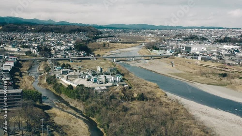 Recycling Center Between Tama And Hirai River With Tama And Nagata Bridge In The Distance In Fussa, Tokyo, Japan. - aerial photo