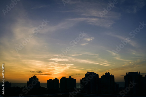 sunset at sea and silhouettes of buildings