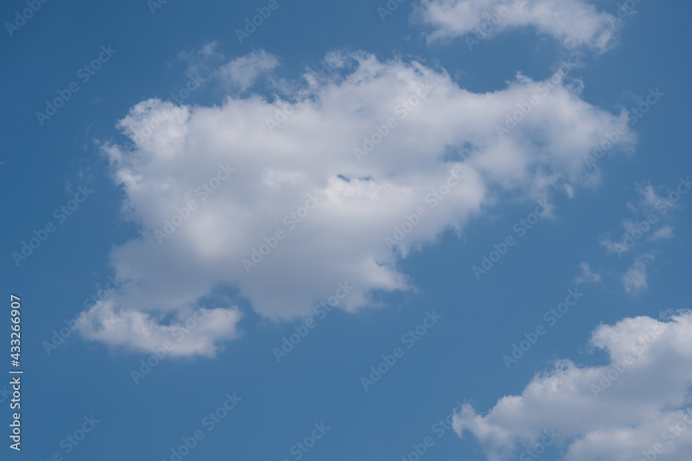 Puffy white clouds against the blue sky. Sky with clouds background with copy space Puffy white clouds against the blue sky. Sky with clouds background with copy space
