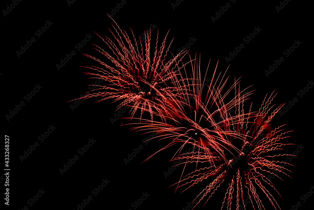 Bright festive fireworks against the night sky. Firework Fiery flowers during the holiday.