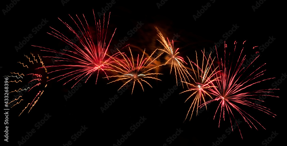 Bright festive fireworks against the night sky. Firework Fiery flowers during the holiday.