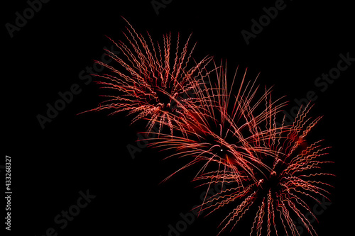 Bright festive fireworks against the night sky. Firework Fiery flowers during the holiday.