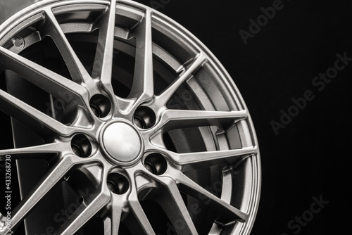 sporty lightweight alloy wheel, spokes and rim close-up on a black background