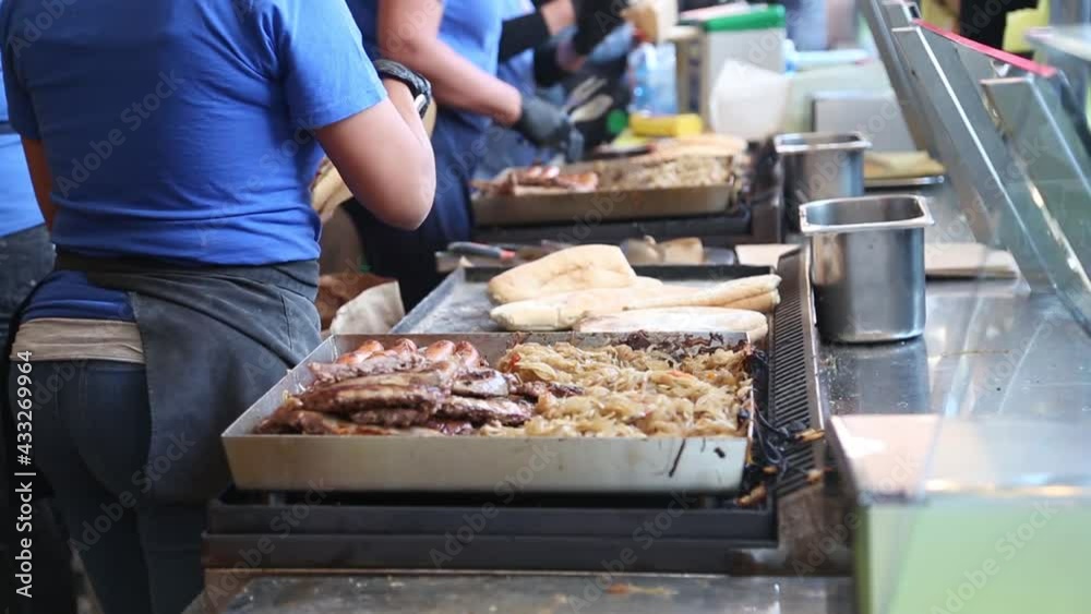 Brescia, Italy - 2020 February 15: Process of making fast food. Preparation of sandwiches at stalls at the feast of patron saint of the city. Brescia, Italy - 2020 February 15: Process of making fast food. Preparation of sandwiches at stalls at the feast of patron saint of the city.
