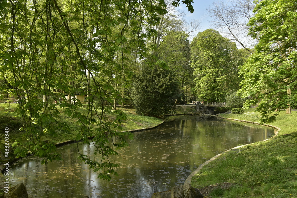 L'un des étangs et le pont rustique en rocaille à son bout sous la végétation luxuriante du parc Josaphat à Schaerbeek L'un des étangs et le pont rustique en rocaille à son bout sous la végétation luxuriante du parc Josaphat à Schaerbeek