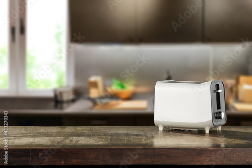 Table background of free space and white toaster. Morning time in kitchen. 