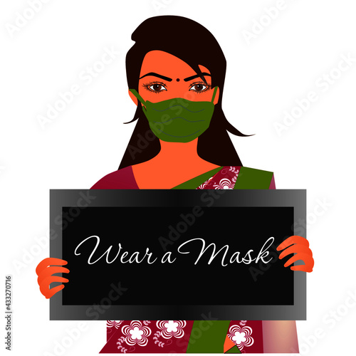 Masked Indian Woman wearing a mask with a board with text Wear a mask, during Covid-19 Pandemic.