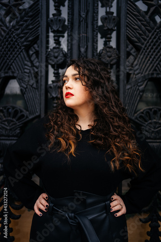 curvy girl with long curly hair in black