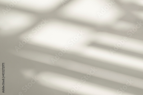 Abstract shadow and striped diagonal light background on white wall from window