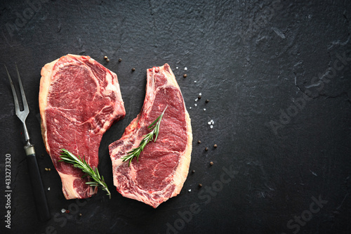 Two raw dry aged beef rib steaks (cote de boeuf)