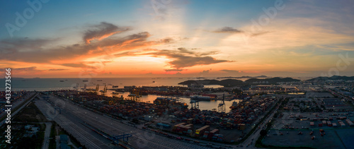 Aerial view of sunset sky at international cargo sea port. © Yellow Boat