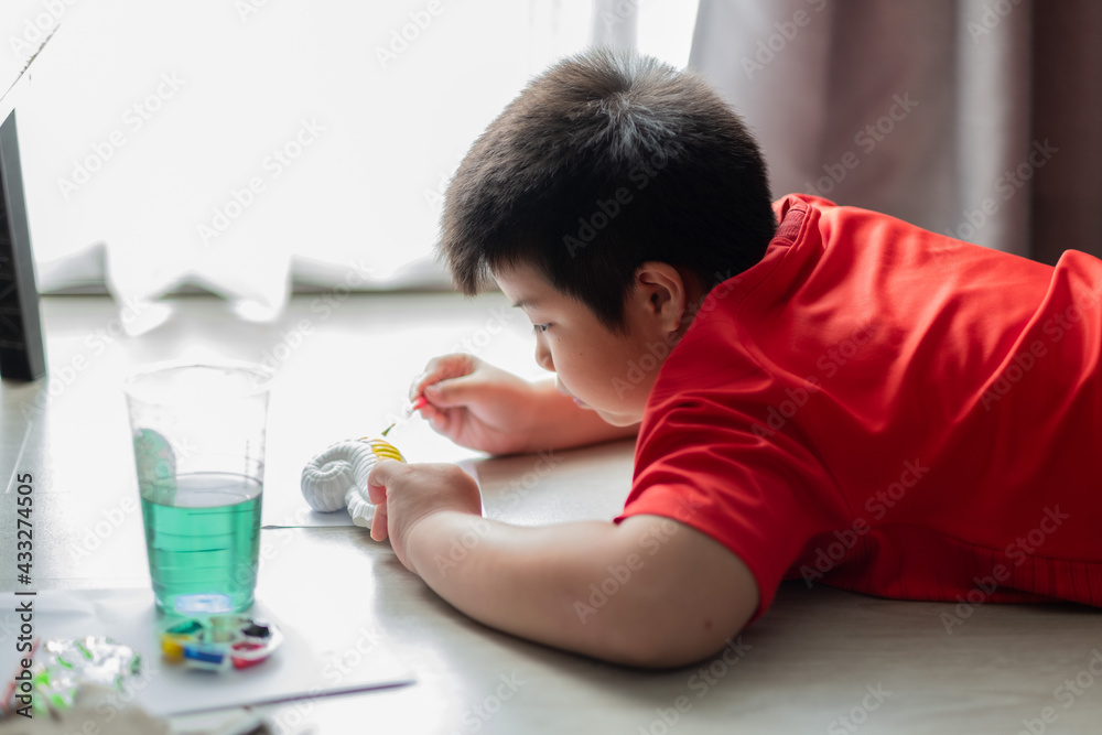 asian kid paint color on paper, education concept