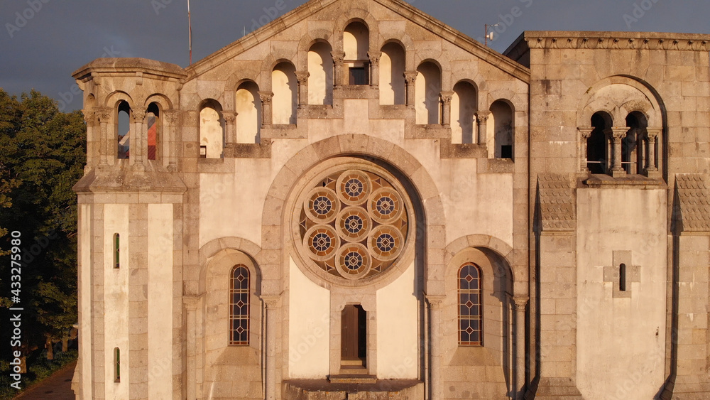DRONE AERIAL VIEW: The Rose window and facade of the church of Nossa Senhora da Assuncao (Our Lady of Assumption) in the hill of Monte Cordoba at sunset in Santo Tirso, Portugal.