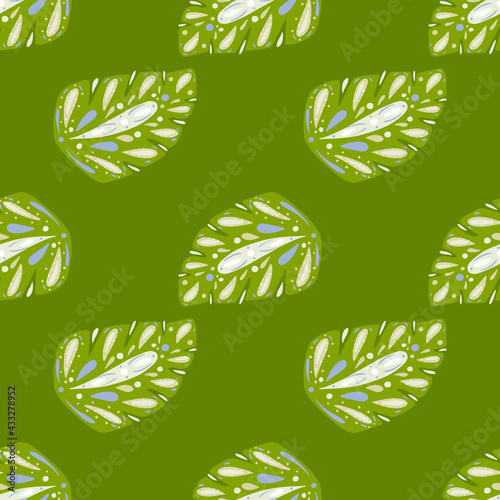 Hand drawn tropic seamless pattern with folk monstera leaf shapes. Green bright background.