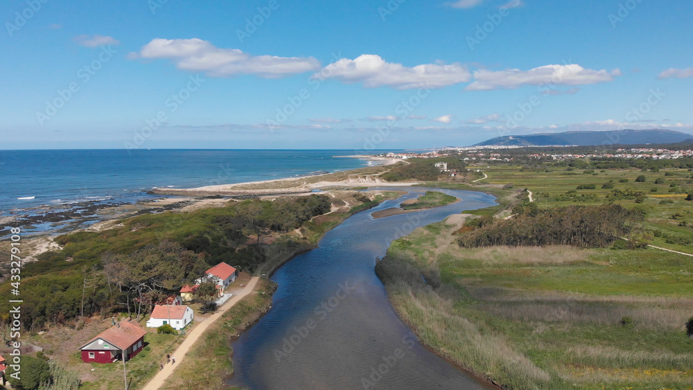 DRONE AERIAL VIEW: The mouth and estuary of Neiva River in Castelo do Neiva, Viana do Castelo, Portugal.
