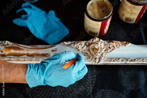 Woman's hand painting frame over table photo