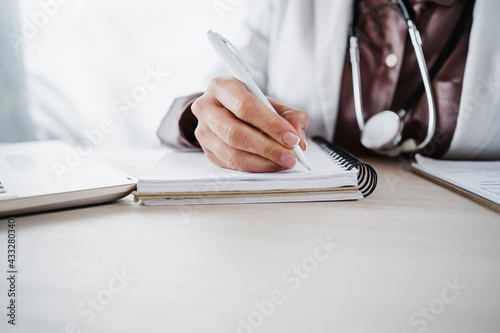 Female medical professional writing in diary