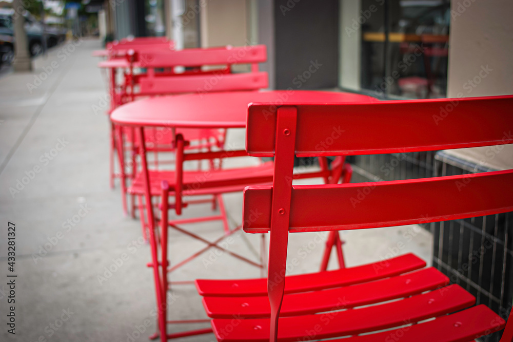Outdoor dining chairs and tables on sidewalk 