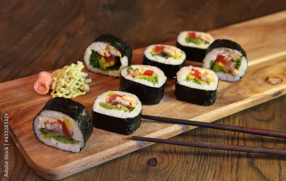 hot roll set sashimi japanese food on wooden background with lemon and chopsticks hot roll set sashimi japanese food on wooden background with lemon and chopsticks