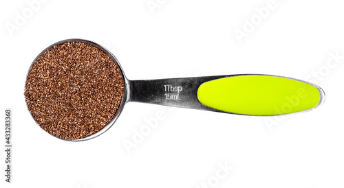 wholegrain teff seeds in measuring spoon cutout photo