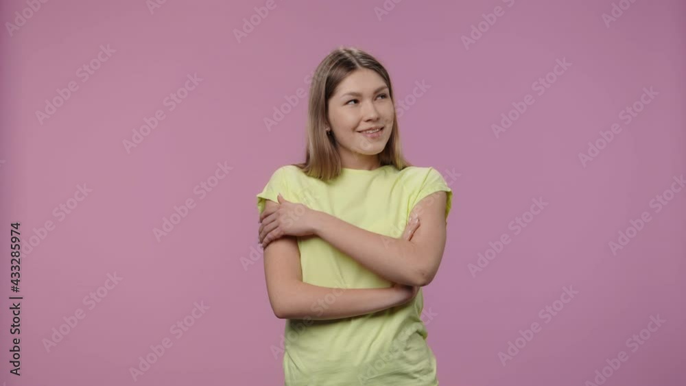 Portrait of model with natural beauty dreaming about something pleasant and smiling. Young girl with long hair in yellow t-shirt poses on purple studio background. Close up. Slow motion ready 59.94fps Portrait of model with natural beauty dreaming about something pleasant and smiling. Young girl with long hair in yellow t-shirt poses on purple studio background. Close up. Slow motion ready 59.94fps