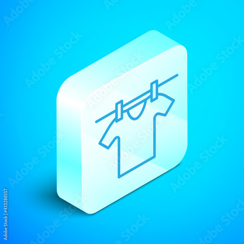 Isometric line Drying clothes icon isolated on blue background. Clean shirt. Wash clothes on a rope with clothespins. Clothing care and tidiness. Silver square button. Vector