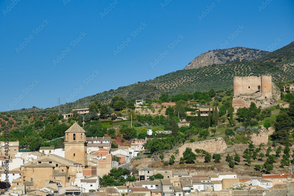 View of the Jienense town of Huelma on a sunny spring morning, highlighting the Renaissance church (16th century) and the ruins of the city's defensive castle
