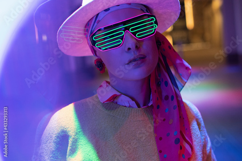Portrait stylish woman with neon glasses