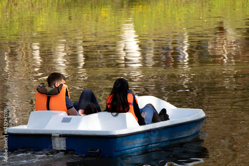 young couple riding a pedal boat