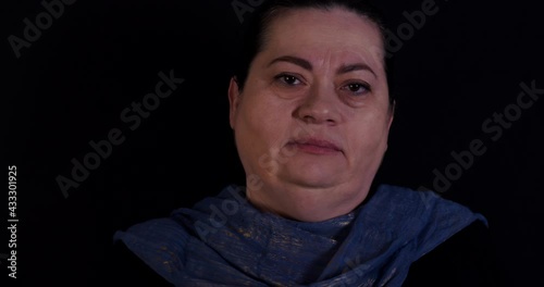 Elder woman raises her eyebrows skeptic